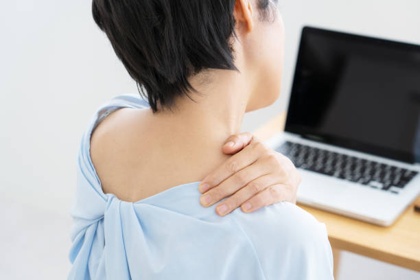 Woman suffering from stiff shoulders stock photo