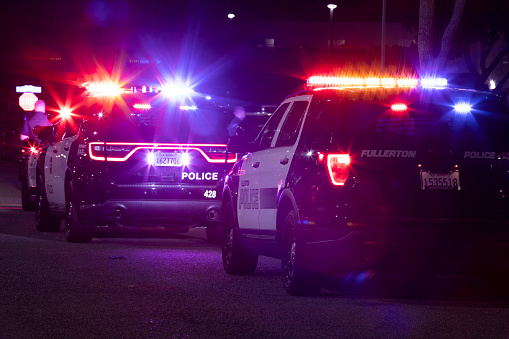 Fullerton, California, USA - December 11, 2022: Fullerton Police Department units respond to the scene of a nighttime emergency.