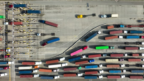 Top Down Aerial Time Lapse of Trucks Entering and Exiting Container Terminal