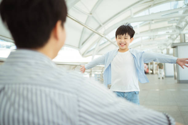 istock Boy running and hugging his father. 1448645369