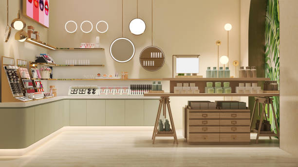 Elegant and luxury interior design of beauty cosmetic shop with wooden and gold shelf, pastel green cabinet and display in cream beige wall and decorative mirror and light stock photo
