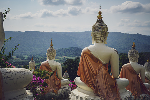 beautiful white stucco Buddha statue  enshrined on the hillside  It is a place of meditation called Wat Sutesuan, Nam Nao District, Thailand.