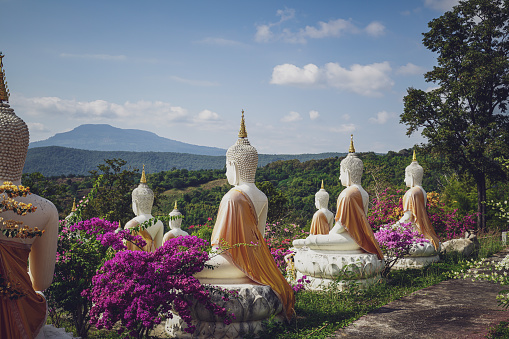 beautiful white stucco Buddha statue  enshrined on the hillside  It is a place of meditation called Wat Sutesuan, Nam Nao District, Thailand.