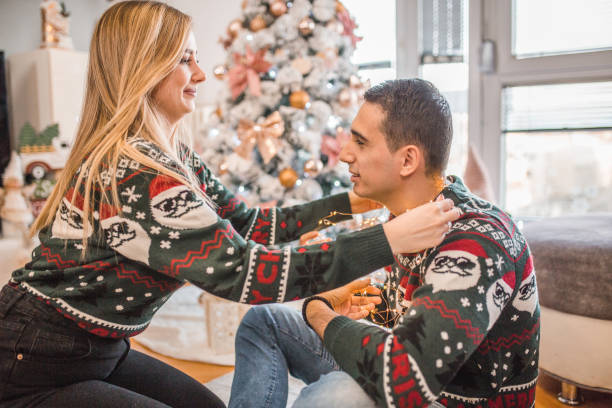 istock A young loving couple has crazy fun with Christmas lights 1448656986