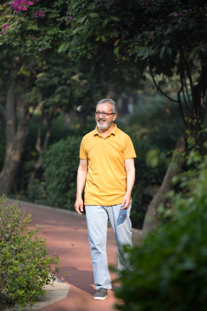istock Happy senior man walking in park during weekend 1448656987