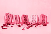 Colored macaroons close-up on a pink background. Side view. New 2023 trending Color Institute 18-1750 Viva Magenta color.