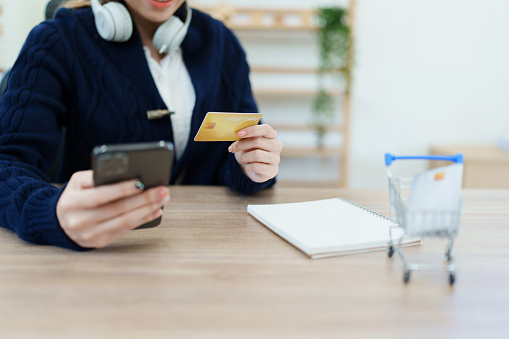 Online Shopping and Internet Payments, Asian man are using their credit card and mobile phone to shop online or conduct errands in the digital world