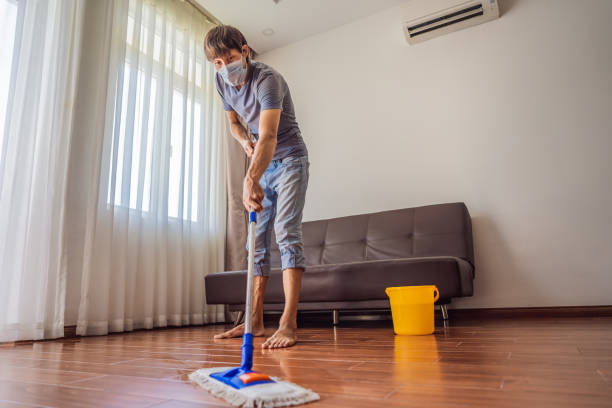 istock Young man with mop cleaning floor at home during coronavirus COVID 19 1448678505