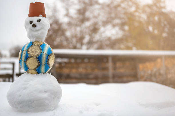 snowman with built-in soccer as a symbol of winter break in a soccer seson - immune defence fotos imagens e fotografias de stock