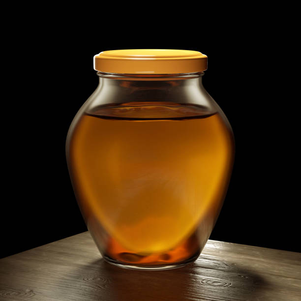 Honey on black background with lid.