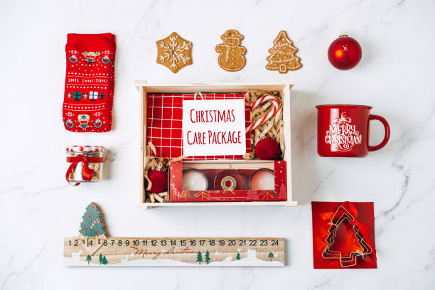 istock Christmas Care Package Gift Boxes. Christmas Baskets Hampers Ideas. Sustainable Eco-Friendly christmas Gift box. Red and brown zero waste box cup, shopper bag, socks, notepad, sweets, cookies 1448689703