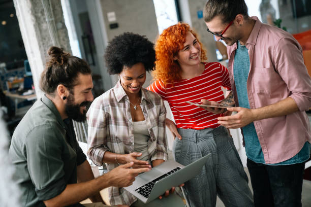 istock Smiling diverse colleagues gather in boardroom brainstorm discuss financial statistics together 1448695314