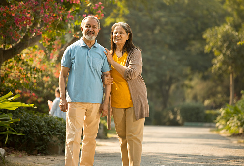 Happy senior couple spending leisure time in park during weekend