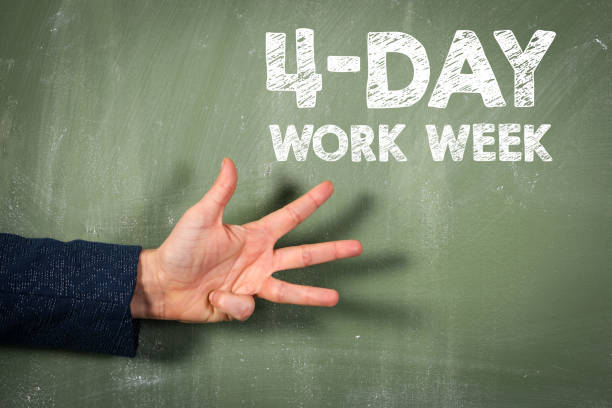 4-day work week. Green chalkboard background and female hand stock photo