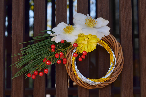 A white sympathy floral arrangement near a grave