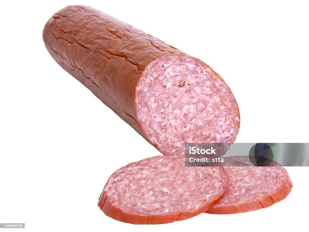 Hard salami and two slices isolated Hard salami and two slices isolated on white background Salami Stock Photo