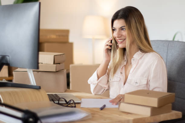 istock Young online shop assistant consulting client on phone 1448698351
