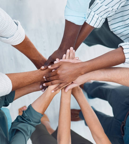 Diversity, hands and team above in support, trust and unity for collaboration, agreement or meeting at the office. Group hand of diverse people in teamwork, cooperation and solidarity for community stock photo
