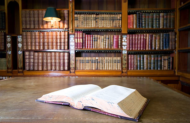 Background of library with open book in old library stock photo