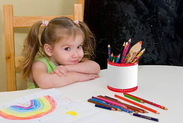 small pretty girl has drawn a rainbow
