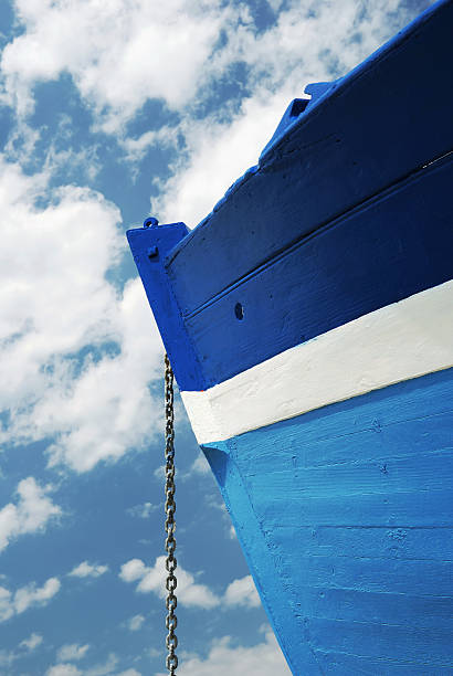 Chain of a white and blue wooden boat stock photo