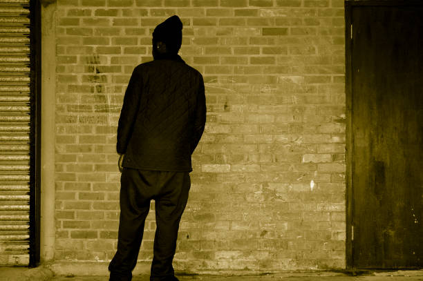 istock silhouette of man against wall 144870246