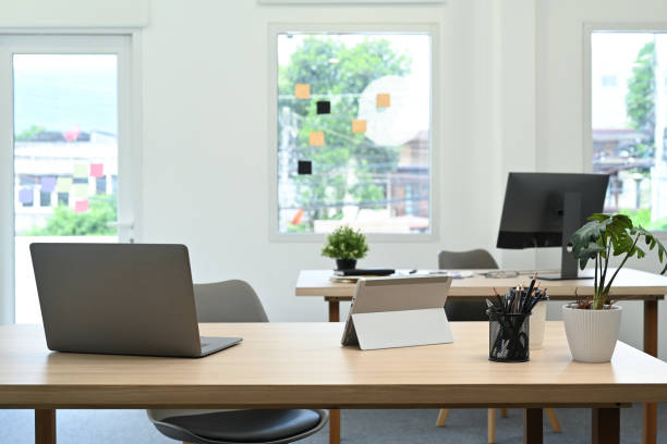istock Modern office interior with laptop computer, documents and various office supplies on wooden table. 1448705286