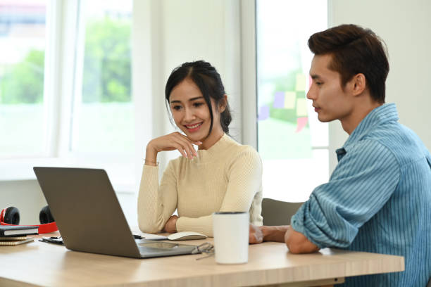 istock Two young creative people brainstorming, working together for design project at office. 1448705309