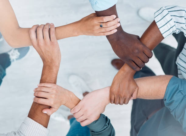 istock Wrist hands, team building and business people support diversity, group and collaboration, cooperation and community mission. Above solidarity, partnership and motivation of goals, trust and teamwork 1448705348