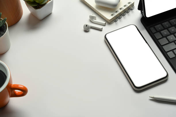 istock Modern workspace mobile phone, coffee cup and wireless earphone and notepad. 1448705356