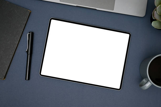 istock Modern workspace top view with tablet mockup, and supplies on blue background. 1448705641