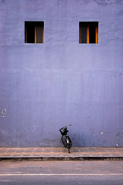 Two Windows and a Parked Bicycle stock photo