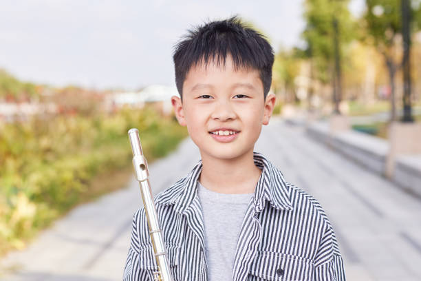 Happy boy with flute smiling at camera