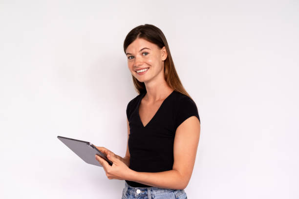 istock Portrait of happy young woman using digital tablet 1448708410