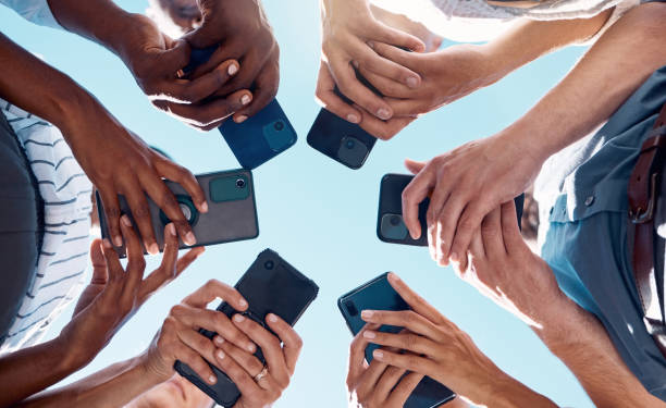 istock Circle people, phone hands and social media mobile apps, wifi and digital iot connection on blue sky. Below group social networking, smartphone and 5g internet website for cloud computing technology 1448708558