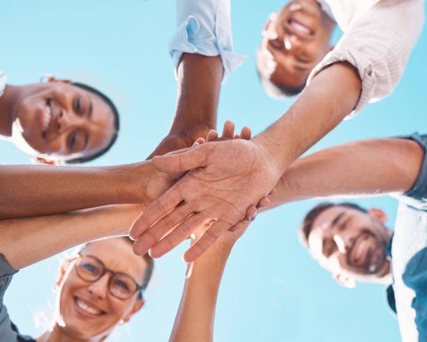 istock Hands stacked, support and friends with motivation for collaboration, partnership and community with a blue sky. Low view of people with a goal, celebration and solidarity together in summer 1448709566