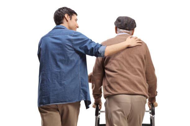 istock Rear view of a young man helping an elderly man with a walker 1448709637