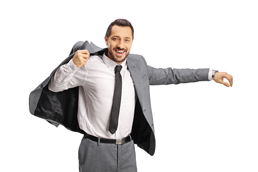 Smiling man putting on a suit and looking at camera isolated on white background