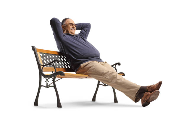 Careless mature man sitting on a bench and resting isolated on white background