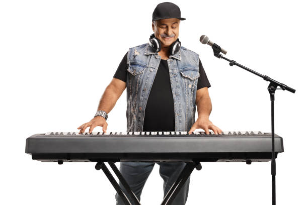 istock Mature man playing a digital piano and singing 1448709702