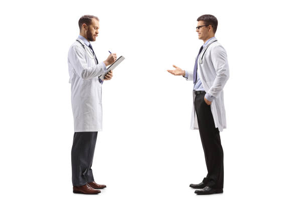 istock Doctor talking to a colleague standing and writing a document 1448709774