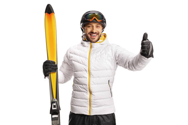 Cheerful male skier holding skiis and showing thumbs up Cheerful male skier holding skiis and showing thumbs up isolated on white background thumbs up for skiing stock pictures, royalty-free photos & images