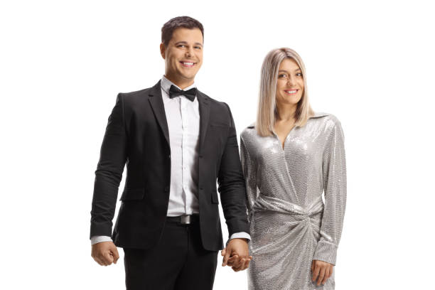 Portrait of a beautiful young Caucasian woman in a prom dress and her partner in a suit
