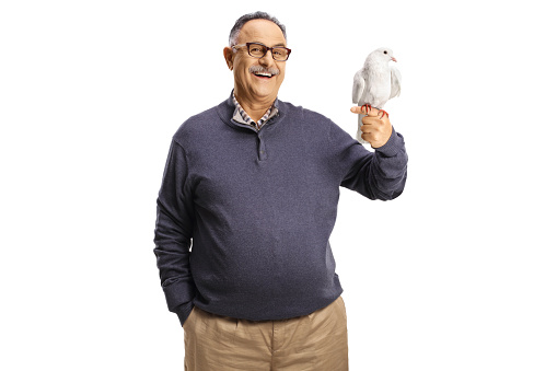 Mature man with a white dove on his hand isolated on white background