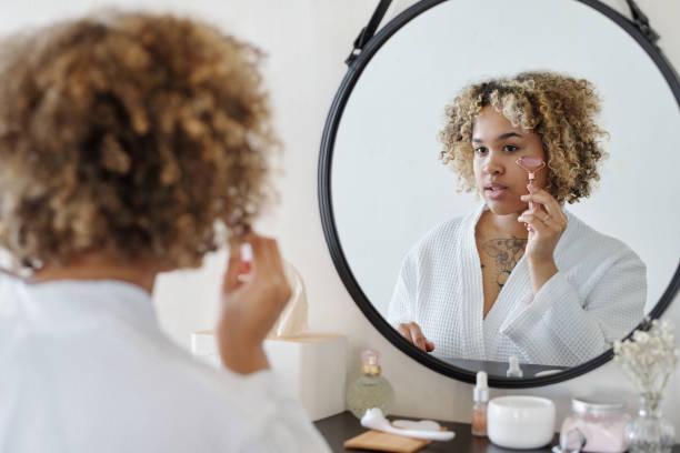 istock Young woman doing massage of face with quartz roller 1448709974