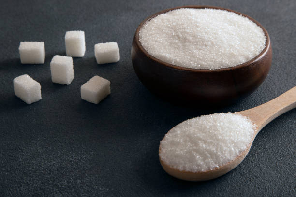 istock Cube sugar and granulated sugar on dark background 1448710074
