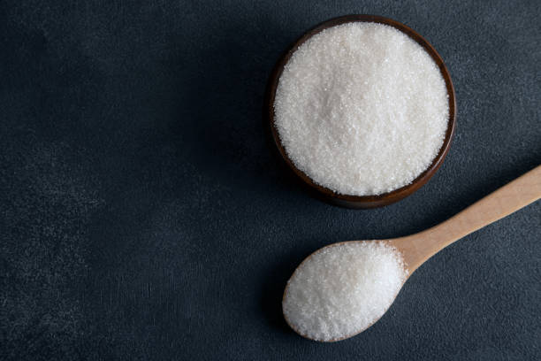 istock Granulated sugar in bowl on dark background,directly above 1448710147