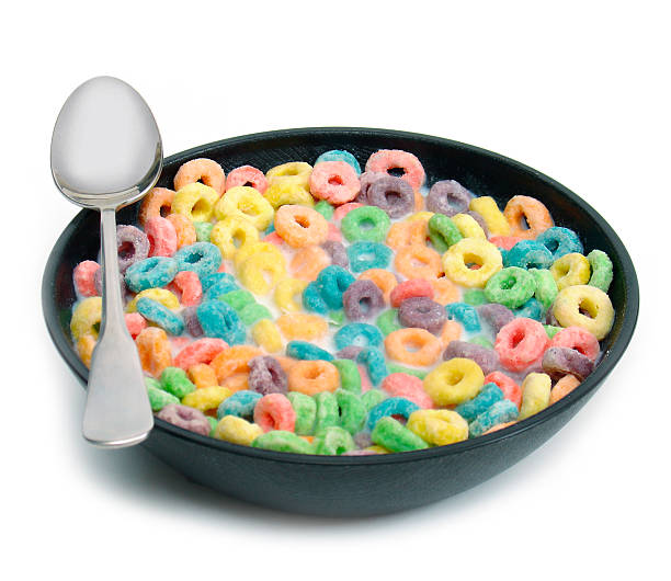 Isolated bowl of colorful loop cereal with spoon stock photo