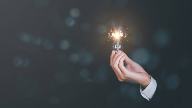 istock solution concept and demonstrating leadership strategies,Creativity that will lead business in the right direction,with innovation and brain power from brainstorming,businessman holding a light bulb 1448711511