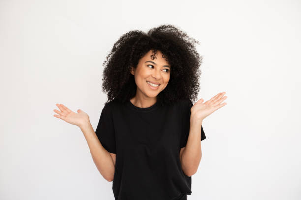 istock Joyful young woman shrugging throwing up hands looking away 1448711925